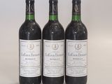 three bottles of wine sitting next to each other on a table