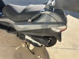 a motor scooter parked on the side of the street