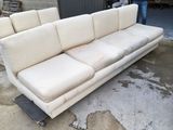 a white couch that is sitting in a garage