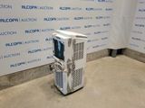 a machine that is sitting on the floor in front of a wall