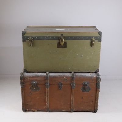 two trunks stacked on top of each other on the floor