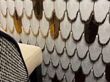 a chair that is next to a wall with beads on it