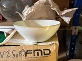 a bowl sitting on top of a box in the middle of a room