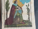 an old book with a picture of a woman holding a child
