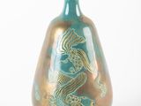 a vase with a dragon on it sitting on a table
