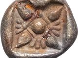 a close up of a coin with a stone design on it