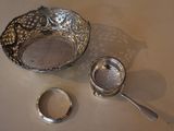 a silver bowl and a spoon on a table