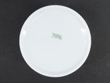 the white plate has a green imprint on it