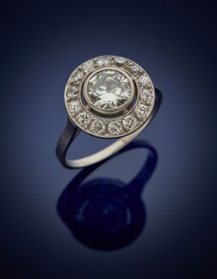 a close up of a diamond ring on a blue surface