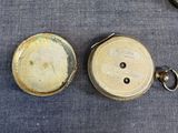 a pocket watch and a pocket watch on a table