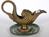 an image of a gold and green teapot on a saucer