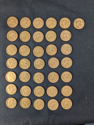 a lot of gold coins that are on a table