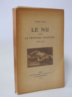 an old book sitting on top of a white table next to a white wall