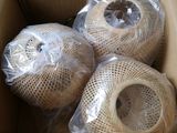 three balls of yarn wrapped in plastic wrap in a box