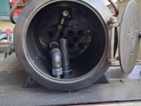 a close up of a train engine with a clock on it ' s side