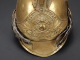 a gold helmet with a crown on it on a black background