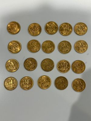 some of the gold coins have been placed on a white surface