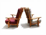 two chairs that are next to each other on a white surface