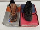 two pairs of shoes sitting on a box on a bed
