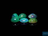 four oplites in a row on a black surface