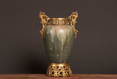 a vase that is sitting on a table with a black background