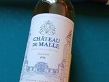 une bouteille de vin et une batte de baseball posées sur une table de billard