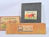 three boxes of assorted items sitting on a white surface
