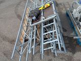a man laying on the ground next to a pile of scaffolding