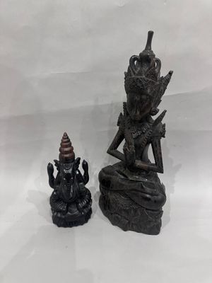 statue of a person sitting on a rock next to a statue of a person sitting on a rock