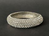 a close up of a silver ring on a black surface