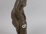 figurine of a female nude with a tag on her chest