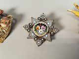 three different types of brooches on a table