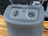 an image of a small air purifier on a wooden table