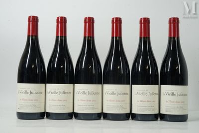 six bottles of red wine are lined up on a table