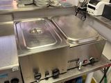 a kitchen with a lot of stainless steel items on the counter