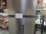 a silver refrigerator in a warehouse with a price tag on it