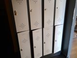 four lockers in the corner of a room with a yellow wall