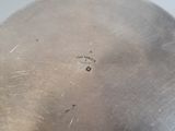 a silver plate on a table with a fork and knife