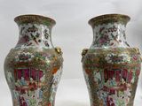 pair of chinese vases with asian scenes on them on a white background