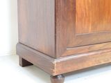 a small wooden cabinet with a door on top of it