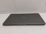 the dell laptop is sitting on a table with its lid open