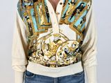 an image of a woman wearing a shirt with a gold and blue design
