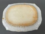 a white plate with a piece of bread on it