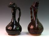 two vases sitting side by side on a white surface