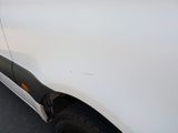 a white van that is parked on the side of the road