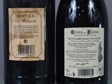 two bottles of wine sitting next to each other on a table