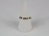 a close up of a white cone with a ring on top of it