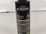 a close up of a bottle of hair color on a table