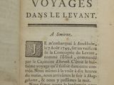 an old book with writing on it and a hand pointing at it
