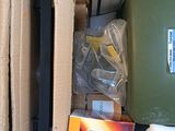 a cardboard box filled with assorted items on the floor